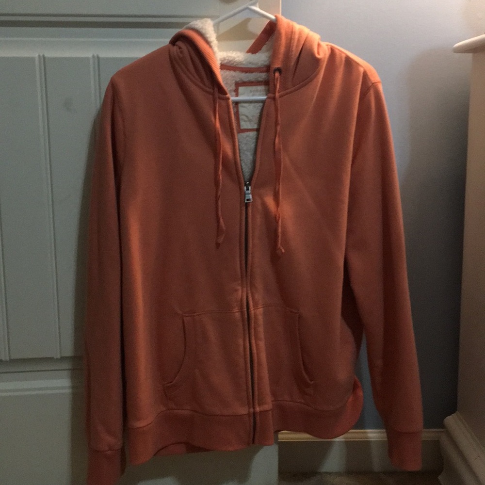 A peach zip-up jacket
